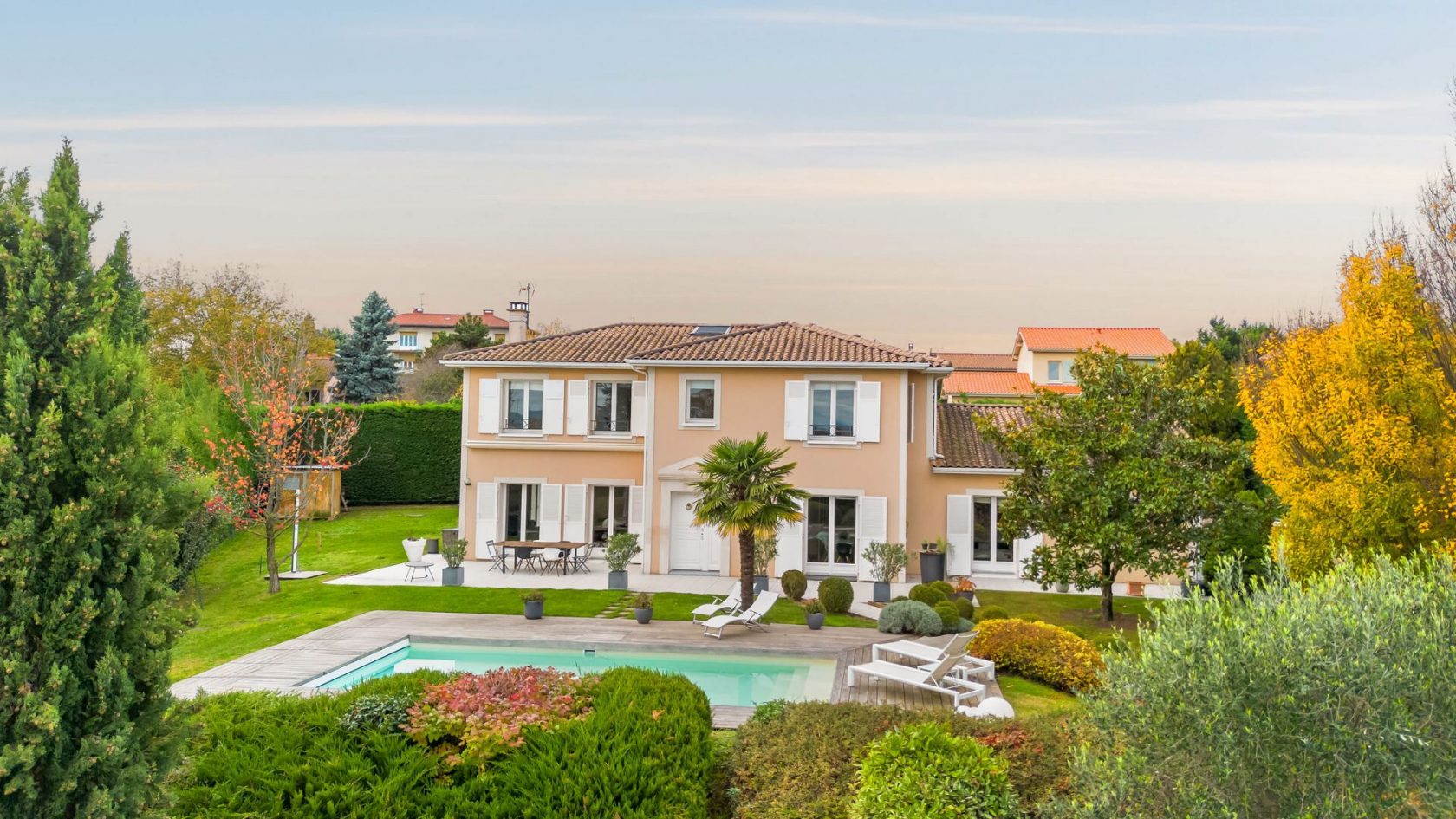 Bright house with swimming pool and tennis court in a green setting with no overlooking neighbors.