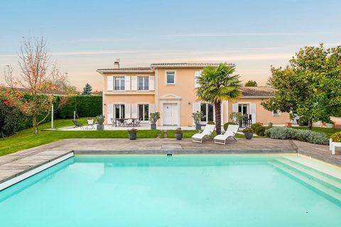 Bright house with swimming pool and tennis court in a green setting with no overlooking neighbors.