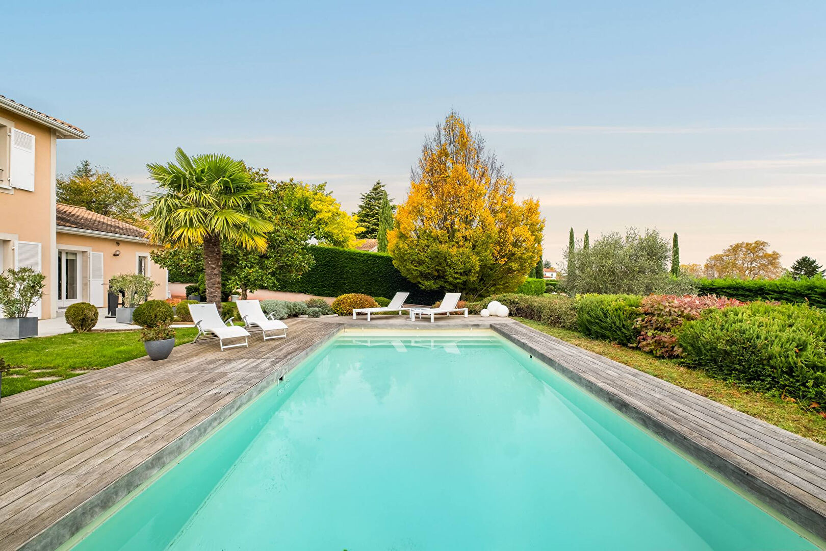 Bright house with swimming pool and tennis court in a green setting with no overlooking neighbors.