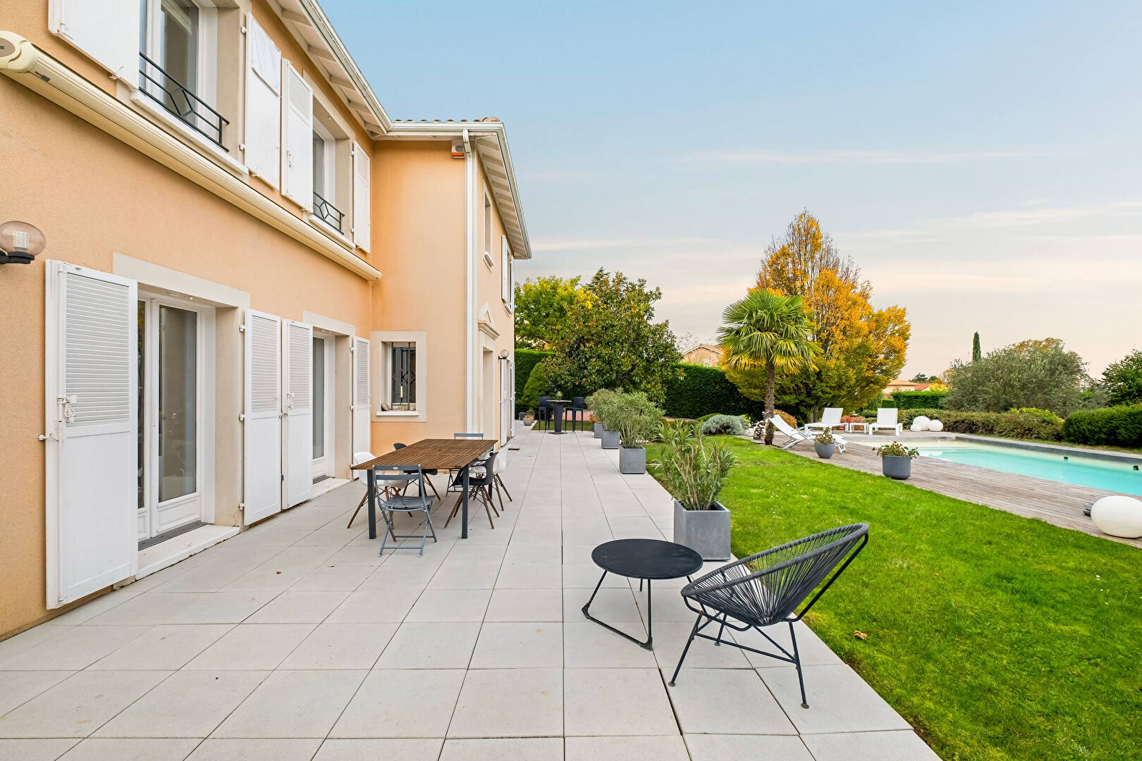 Bright house with swimming pool and tennis court in a green setting with no overlooking neighbors.