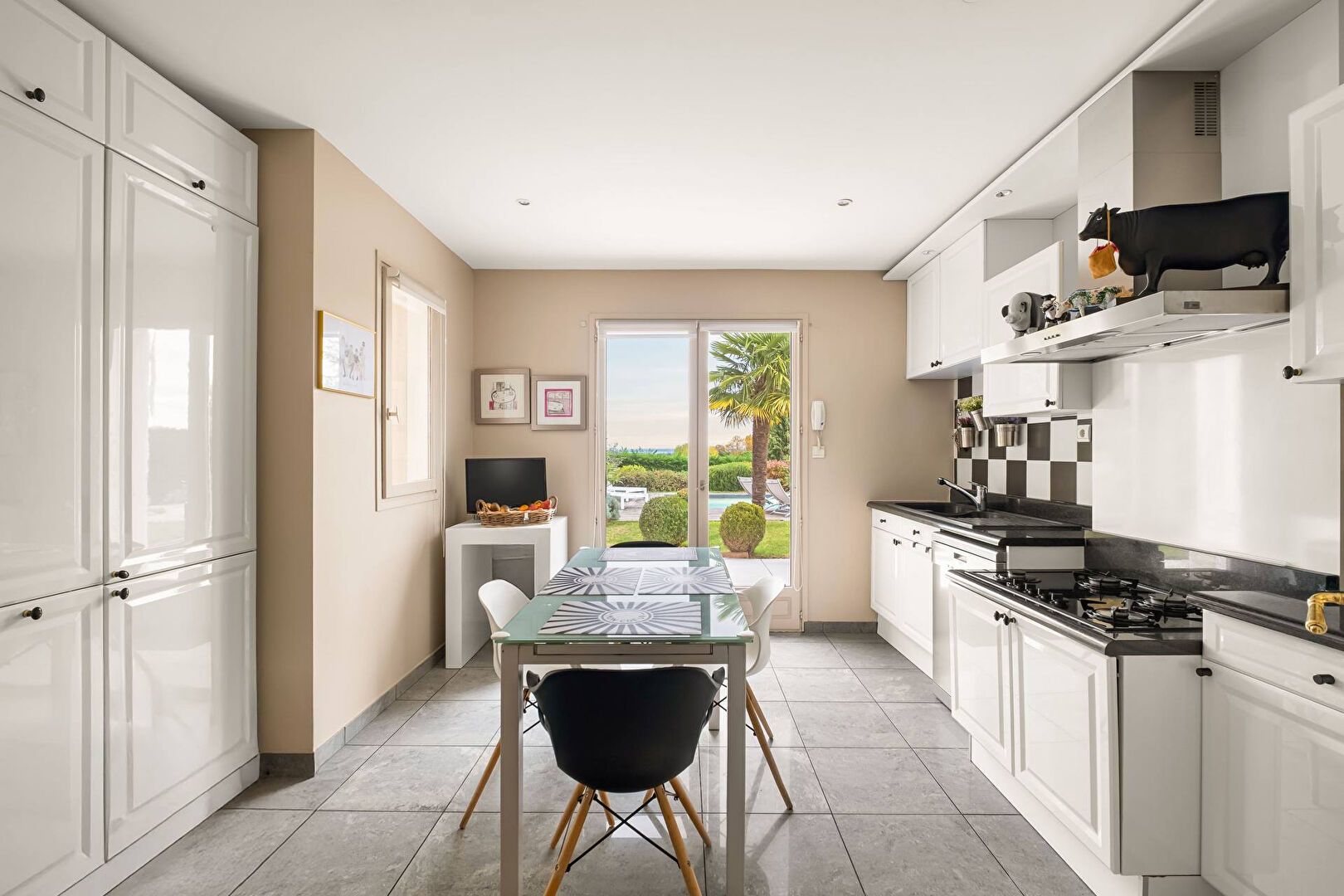 Bright house with swimming pool and tennis court in a green setting with no overlooking neighbors.