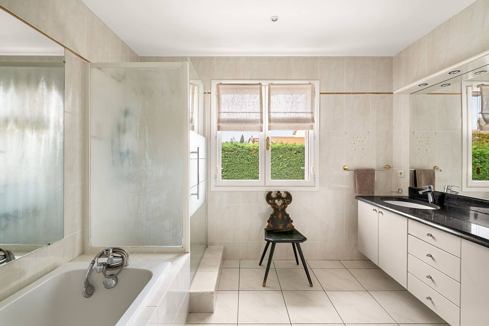 Bright house with swimming pool and tennis court in a green setting with no overlooking neighbors.