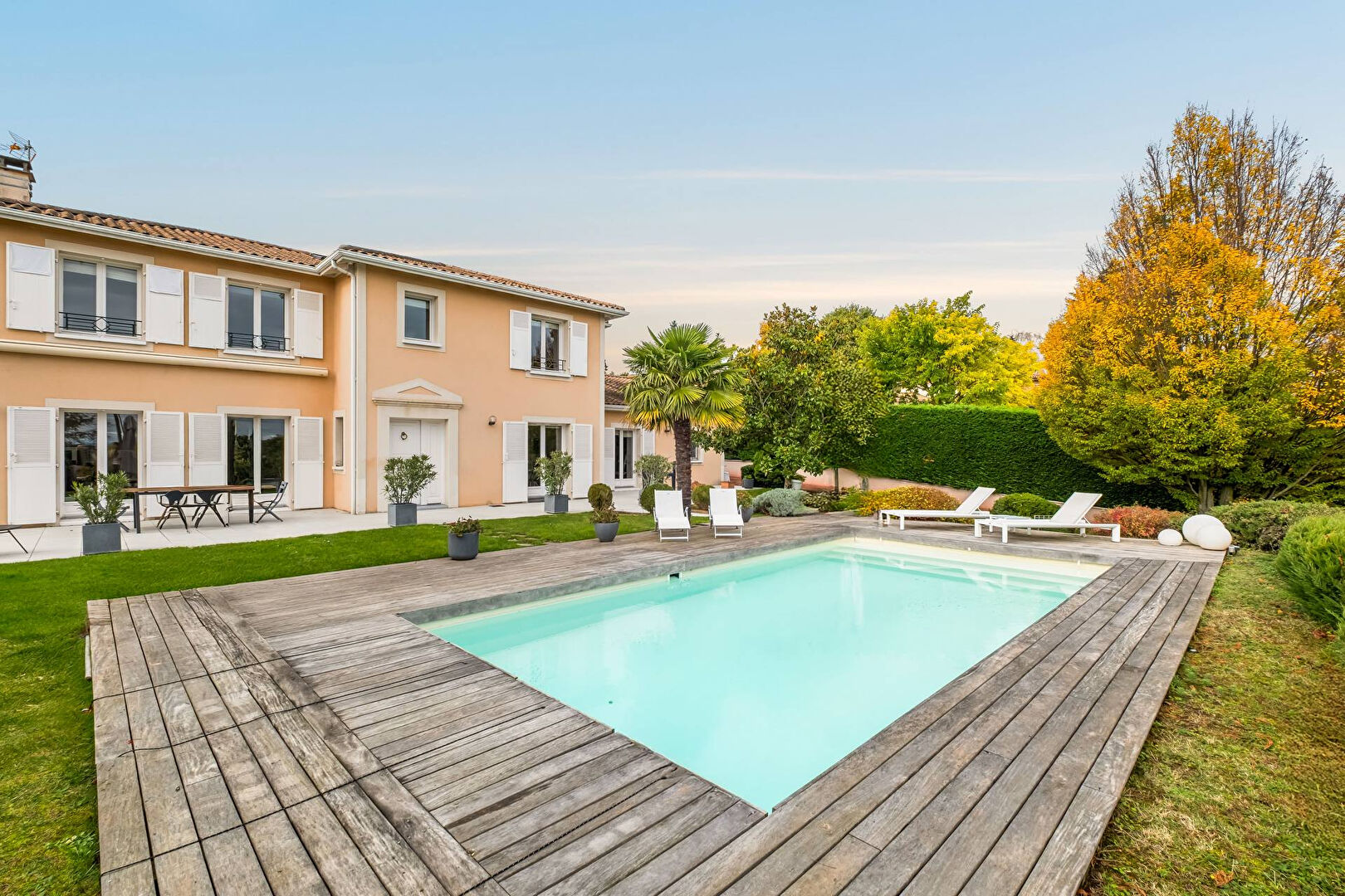 Bright house with swimming pool and tennis court in a green setting with no overlooking neighbors.