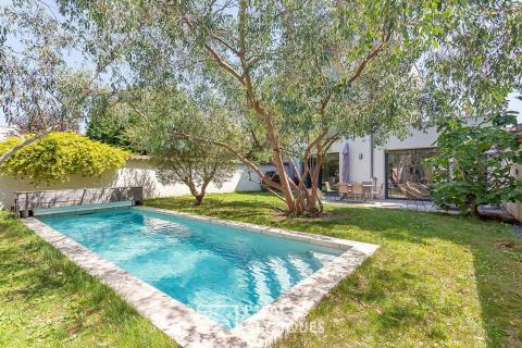 Contemporary house with garden and swimming pool and its outbuilding