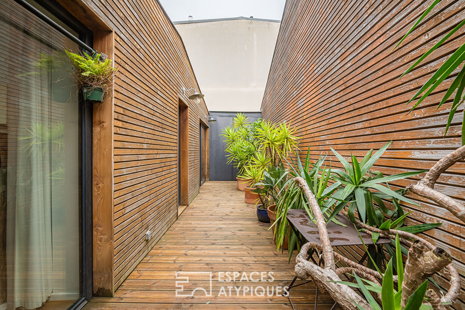 Former car garage transformed with terrace and garage