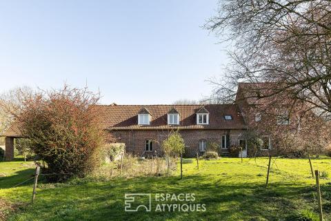 An old square farmhouse in the heart of the fields