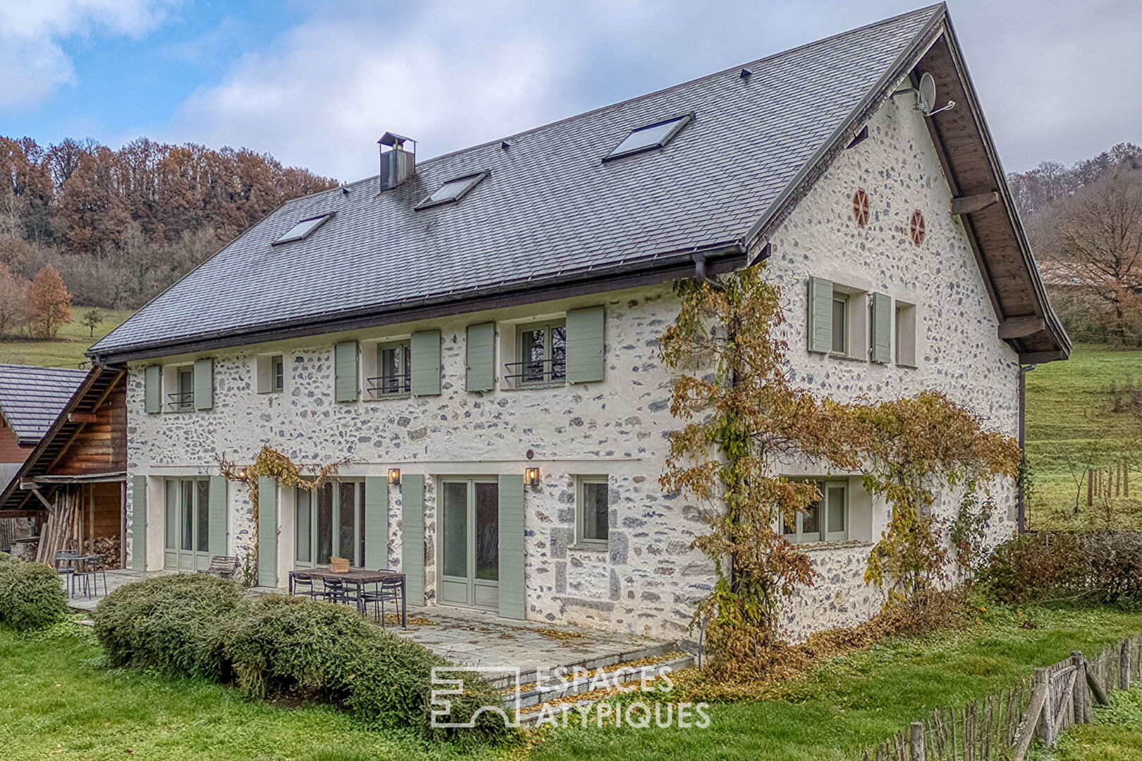 Renovated farmhouse with swimming pool and grounds bordered by a stream