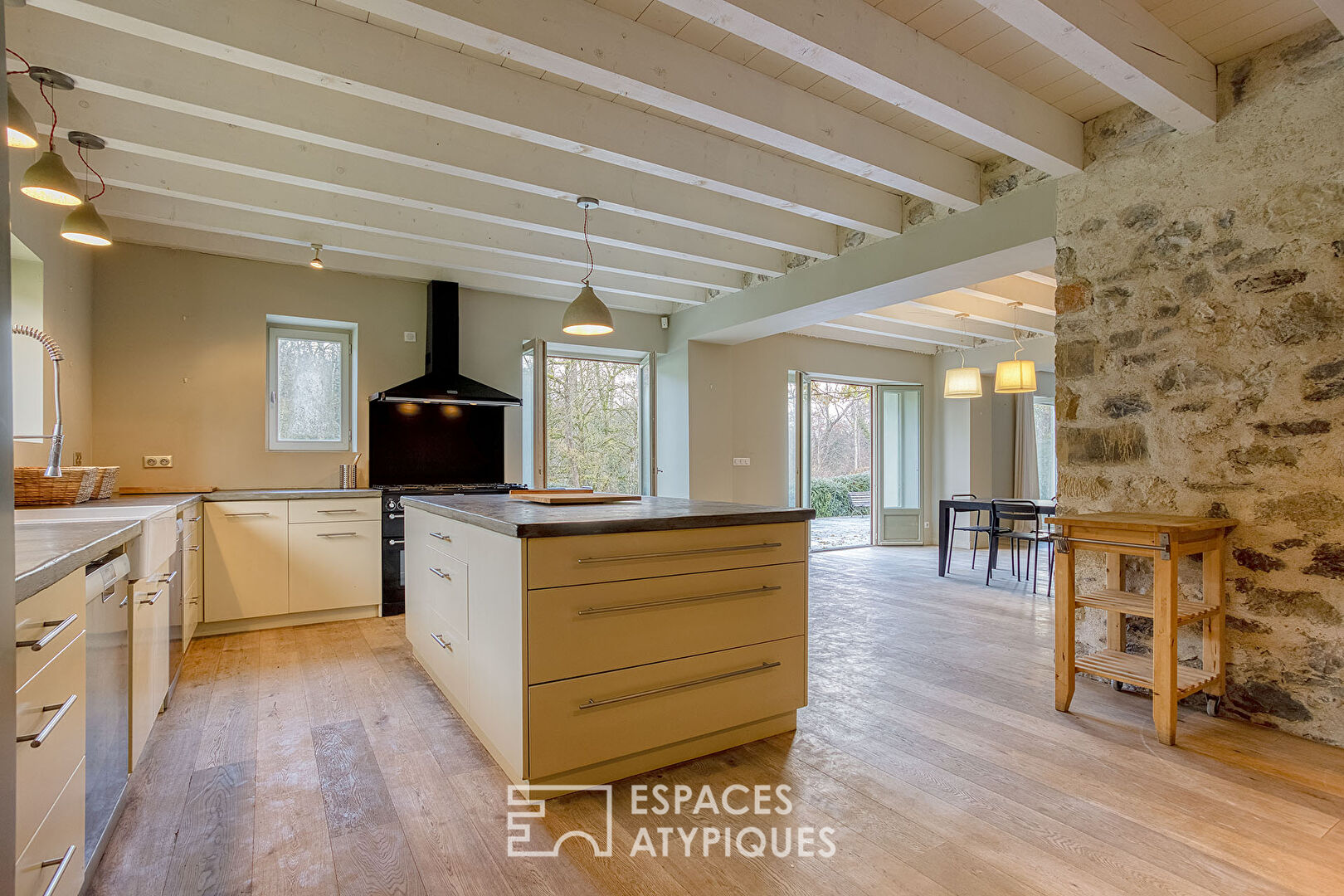 Renovated farmhouse with swimming pool and grounds bordered by a stream