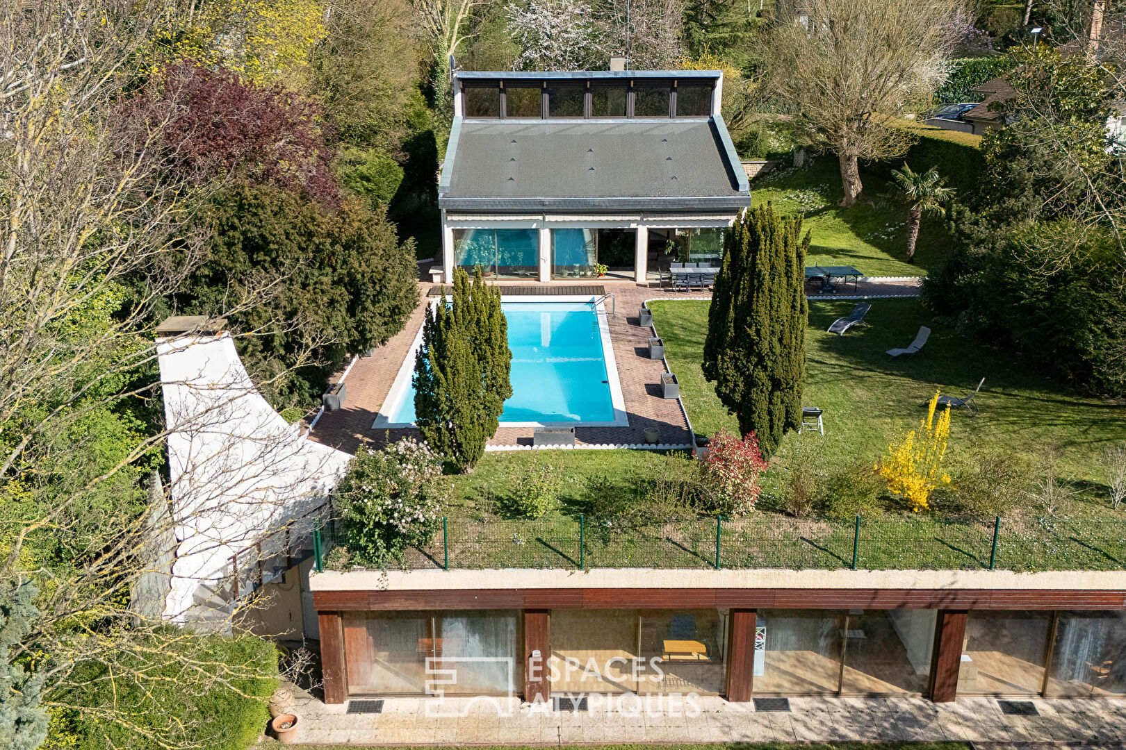 Multifaceted architect-designed house with open views, swimming pool and outbuildings