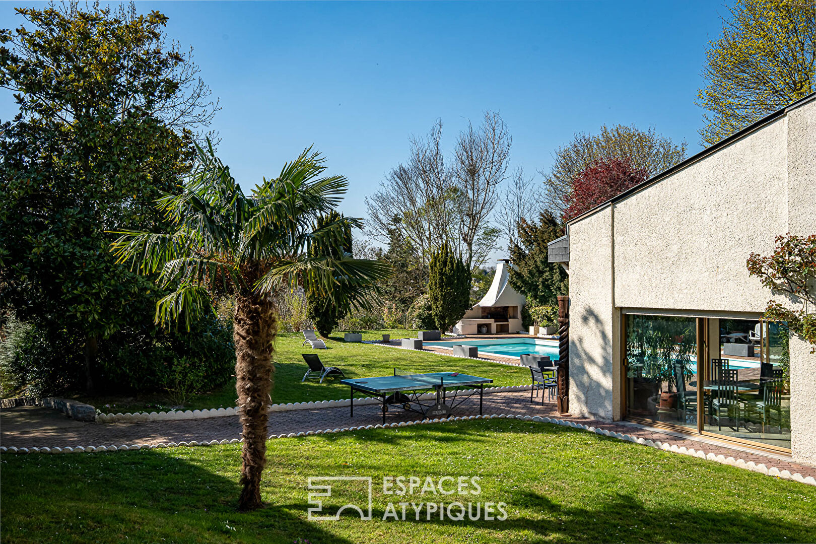Multifaceted architect-designed house with open views, swimming pool and outbuildings