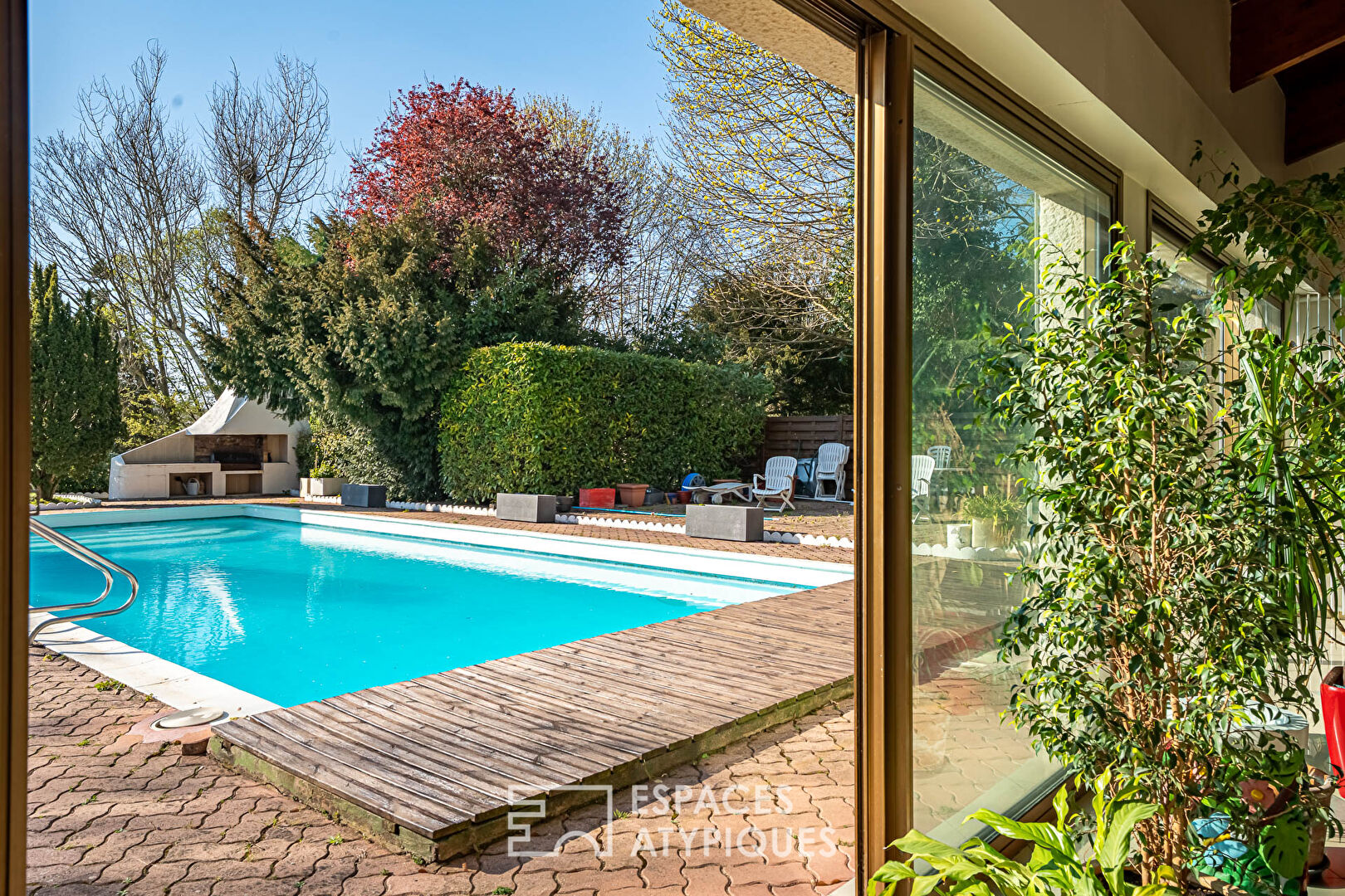 Multifaceted architect-designed house with open views, swimming pool and outbuildings