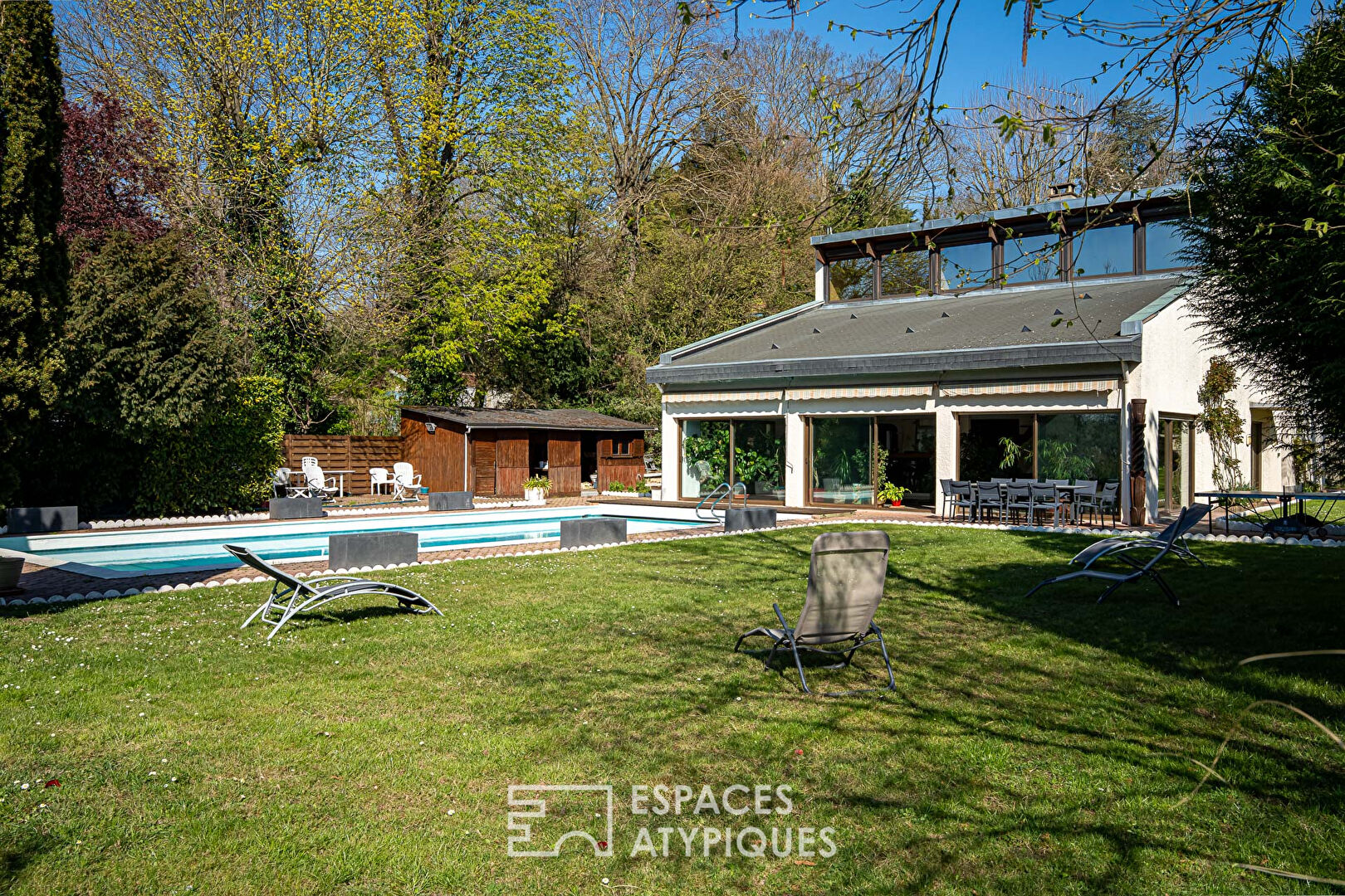 Multifaceted architect-designed house with open views, swimming pool and outbuildings