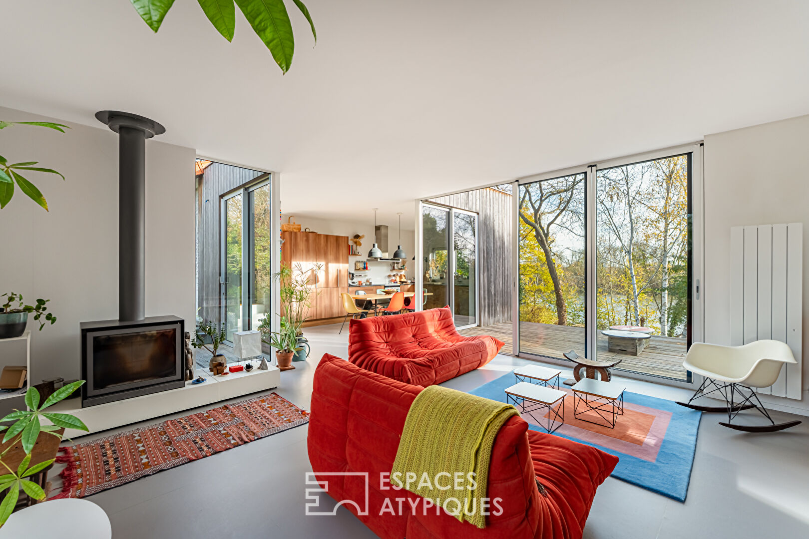 House with contemporary extension on an island and its wooded garden