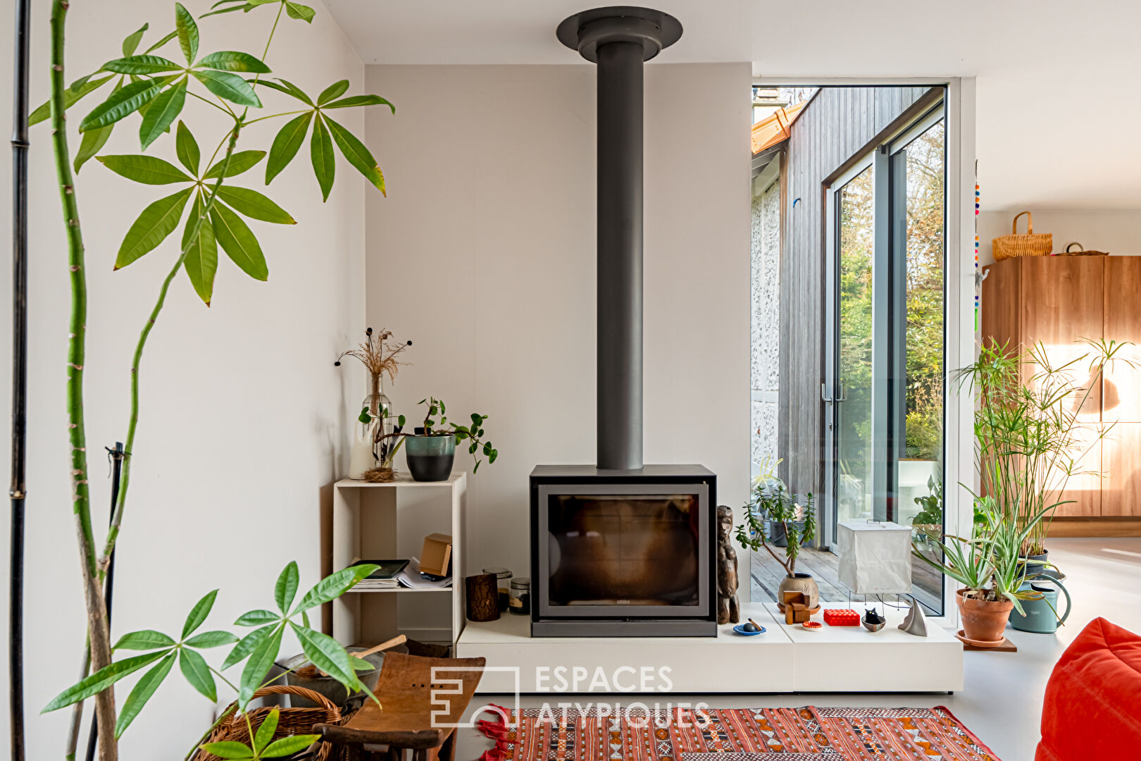 House with contemporary extension on an island and its wooded garden