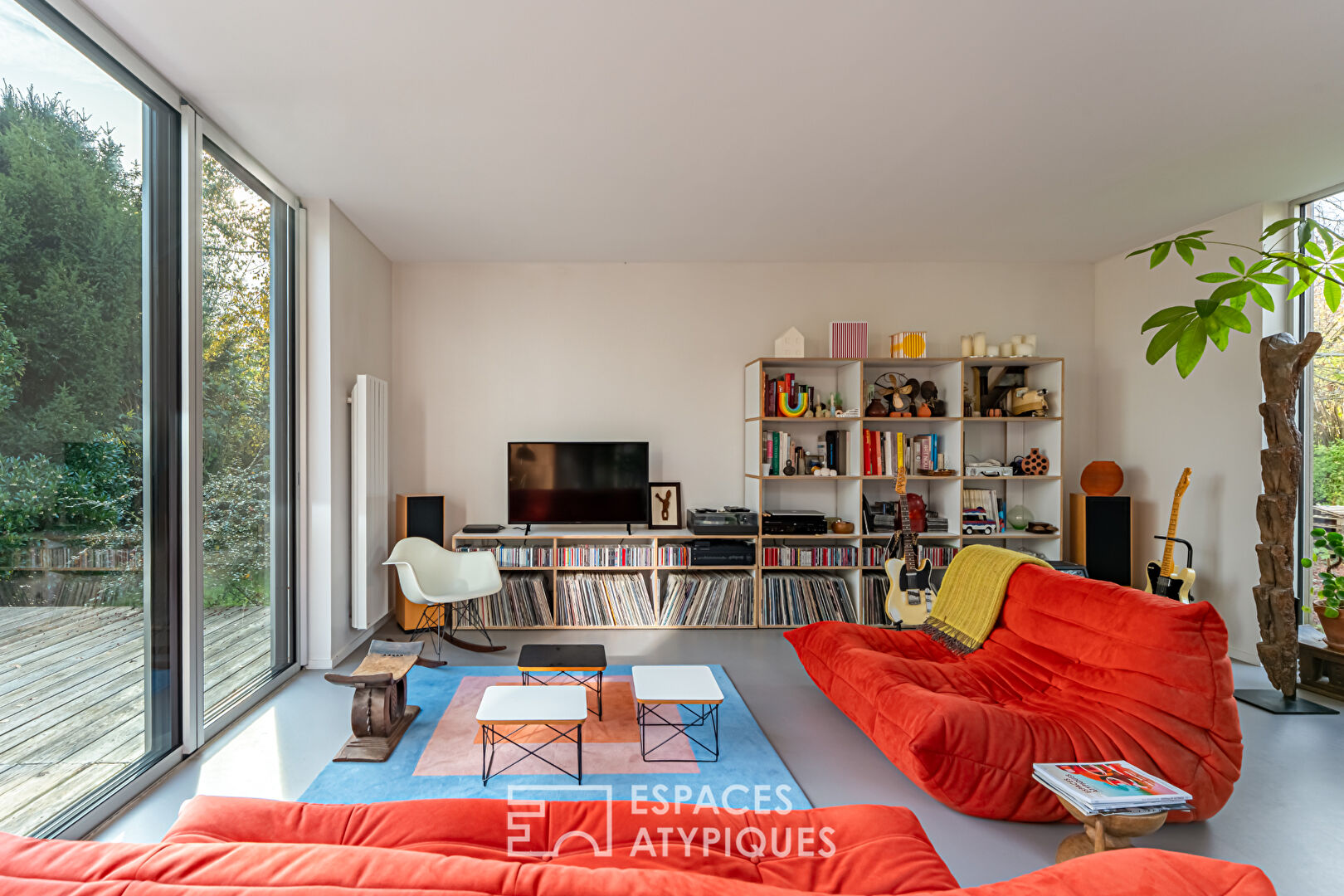 House with contemporary extension on an island and its wooded garden