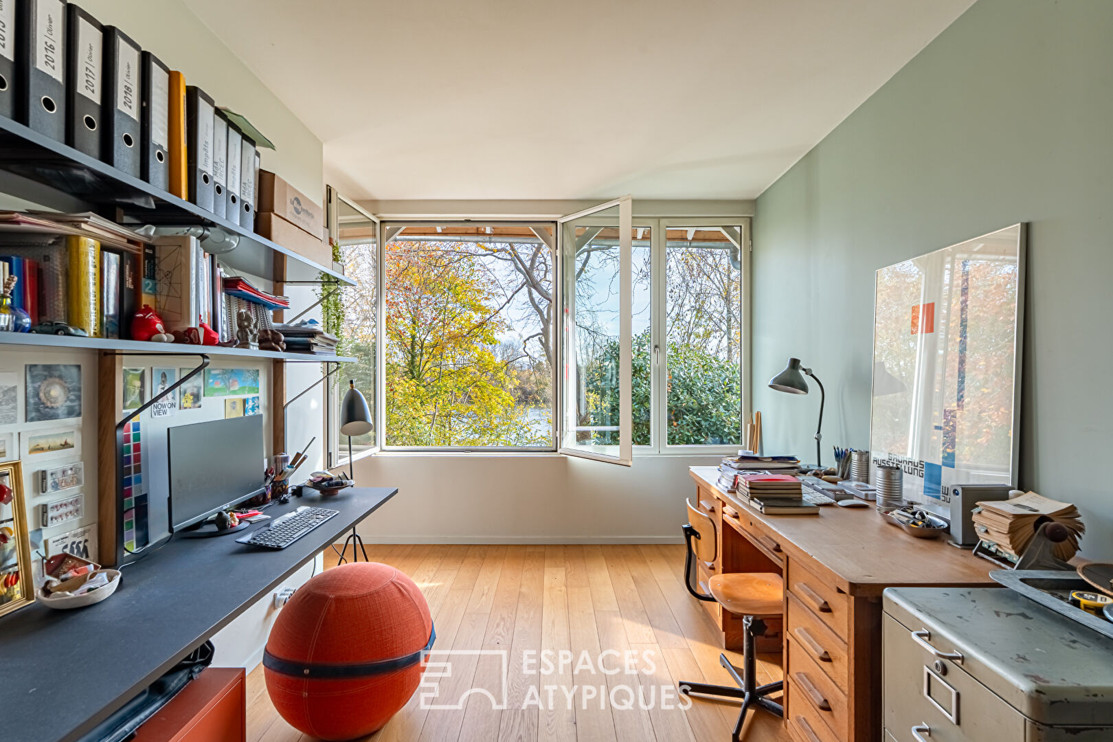 House with contemporary extension on an island and its wooded garden