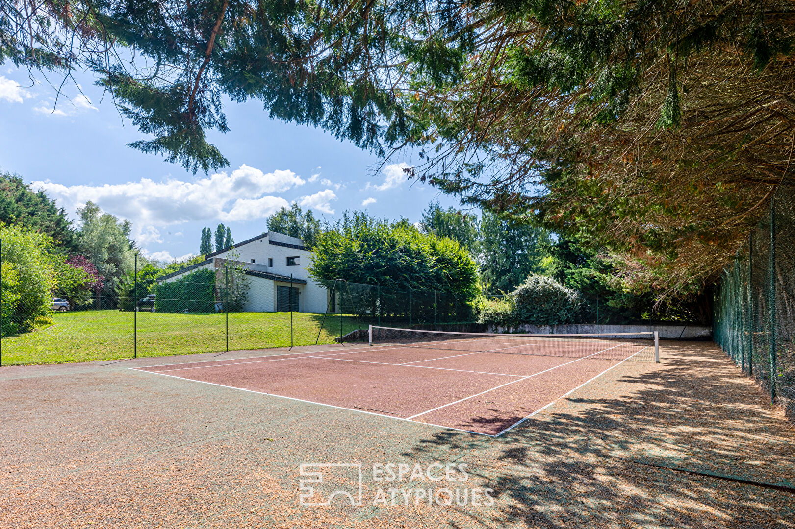 70s architect-designed house with swimming pool and tennis court, in a magnificent green setting
