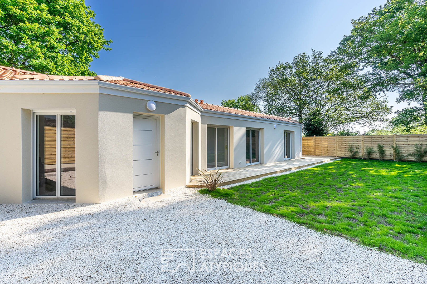 Maison moderne de plain pied avec terrasse et jardin en bord de mer