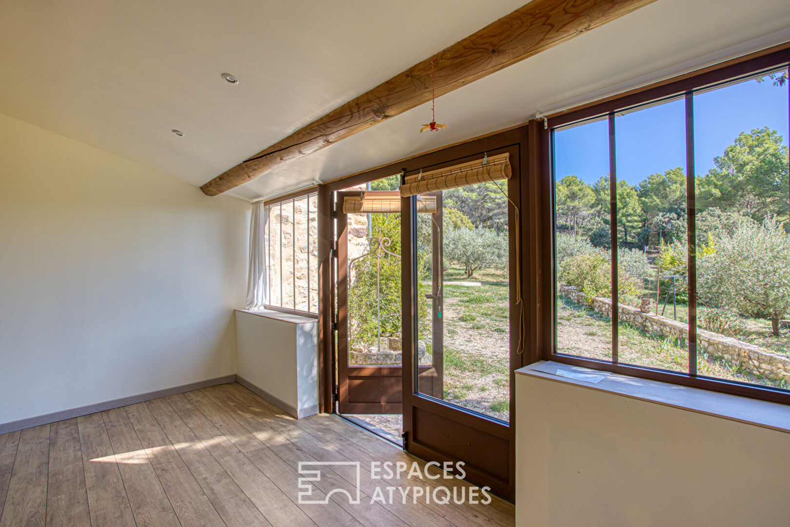 Two stone houses in an olive grove