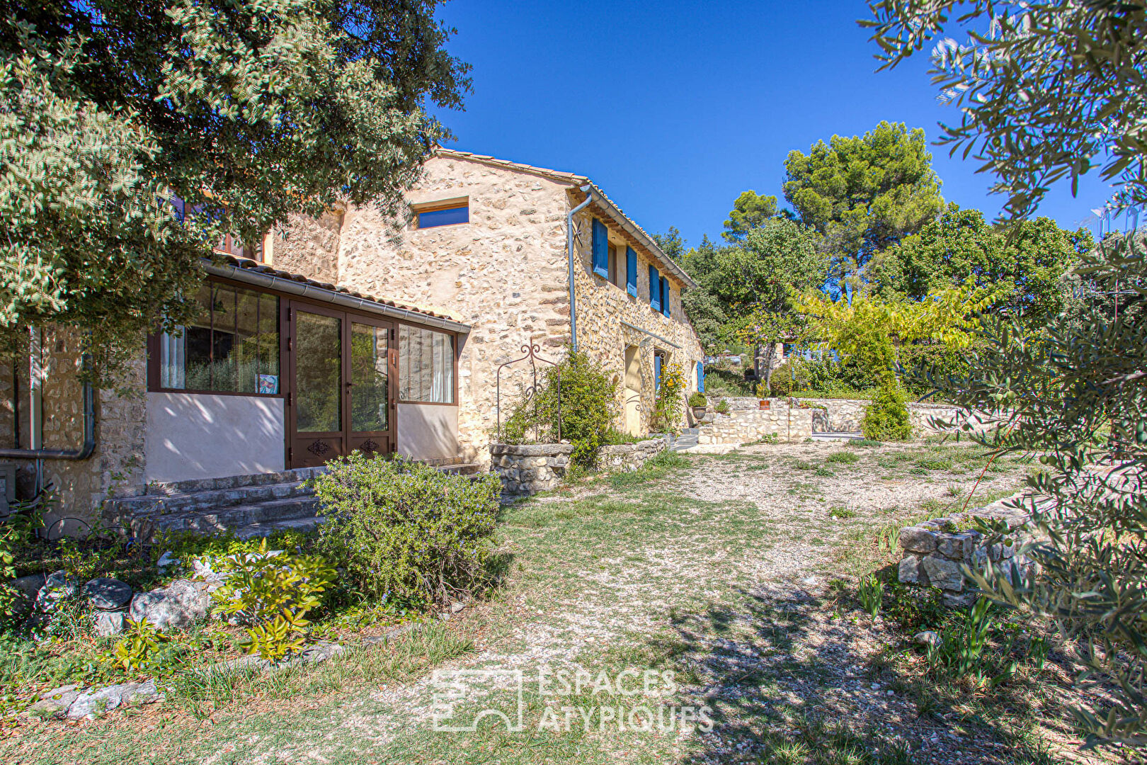 Two stone houses in an olive grove