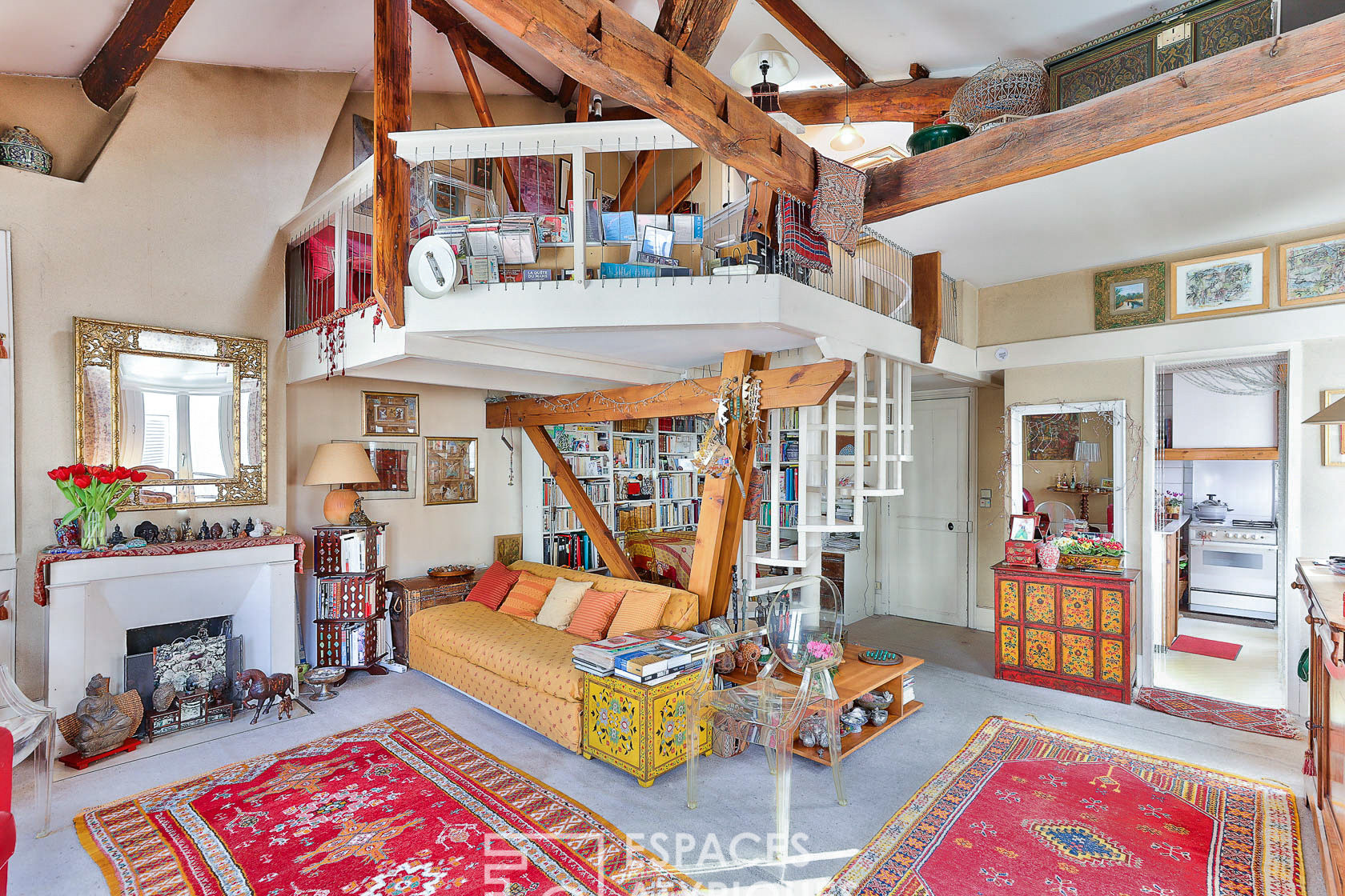Duplex with exposed beams on the top floor