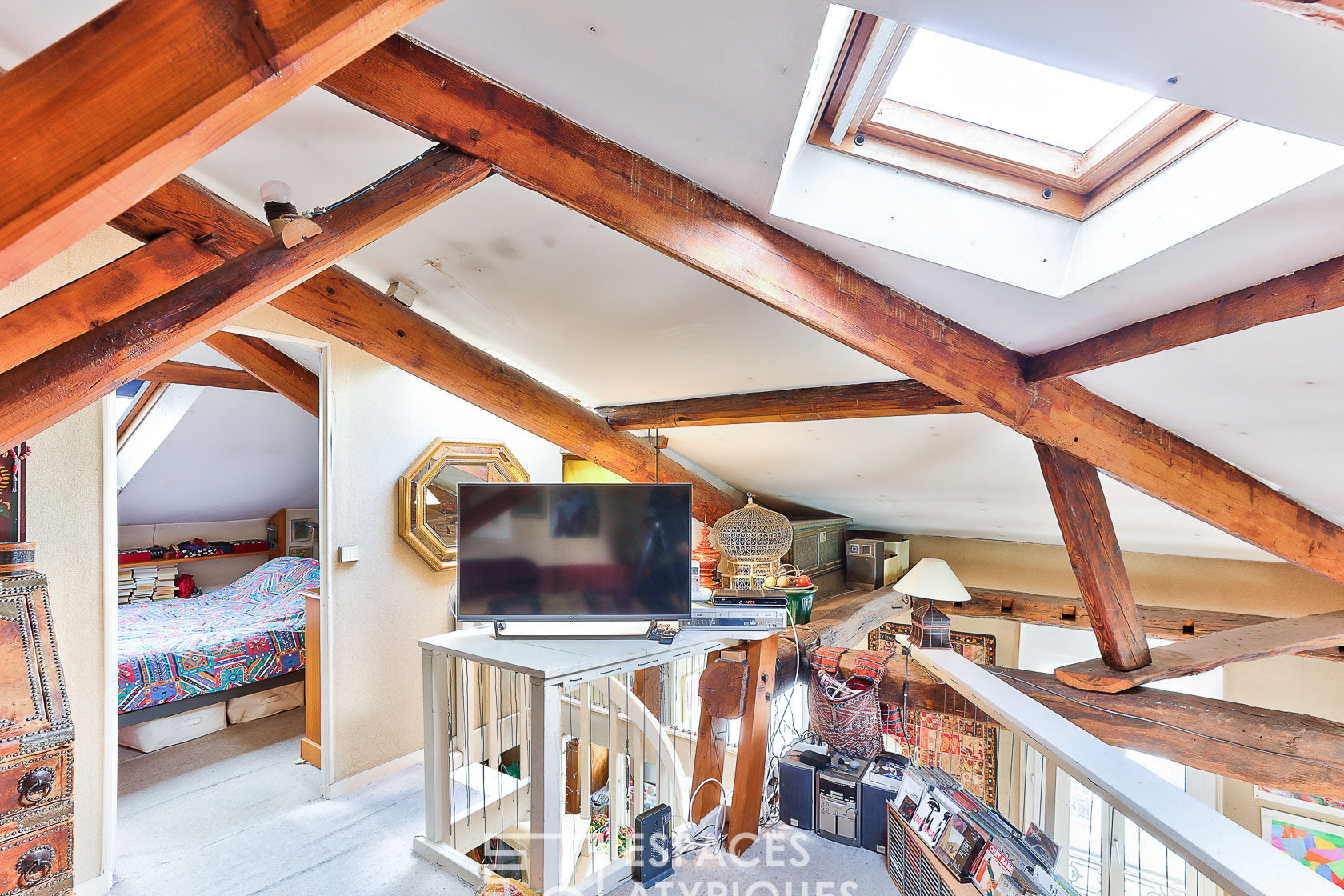 Duplex with exposed beams on the top floor