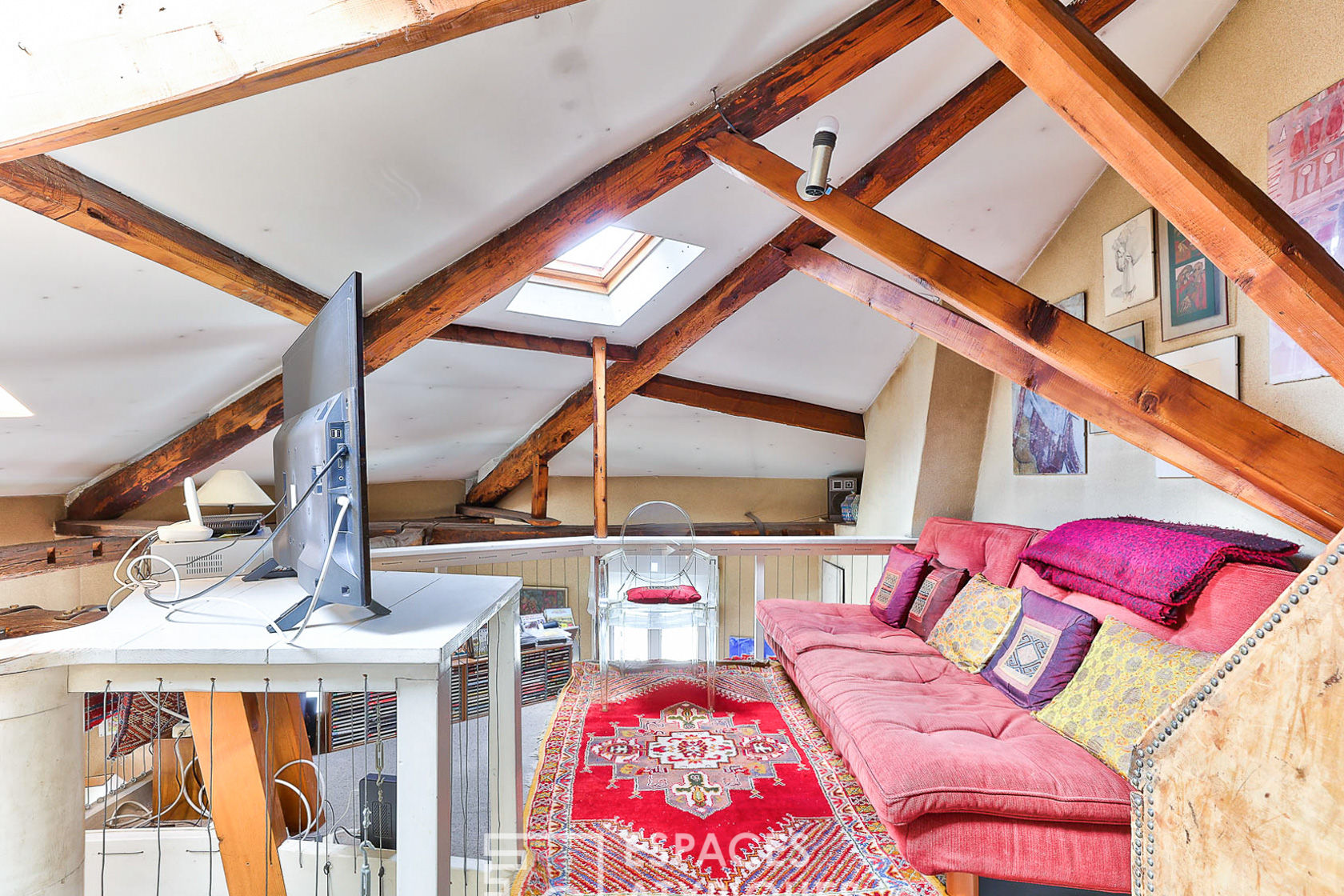Duplex with exposed beams on the top floor