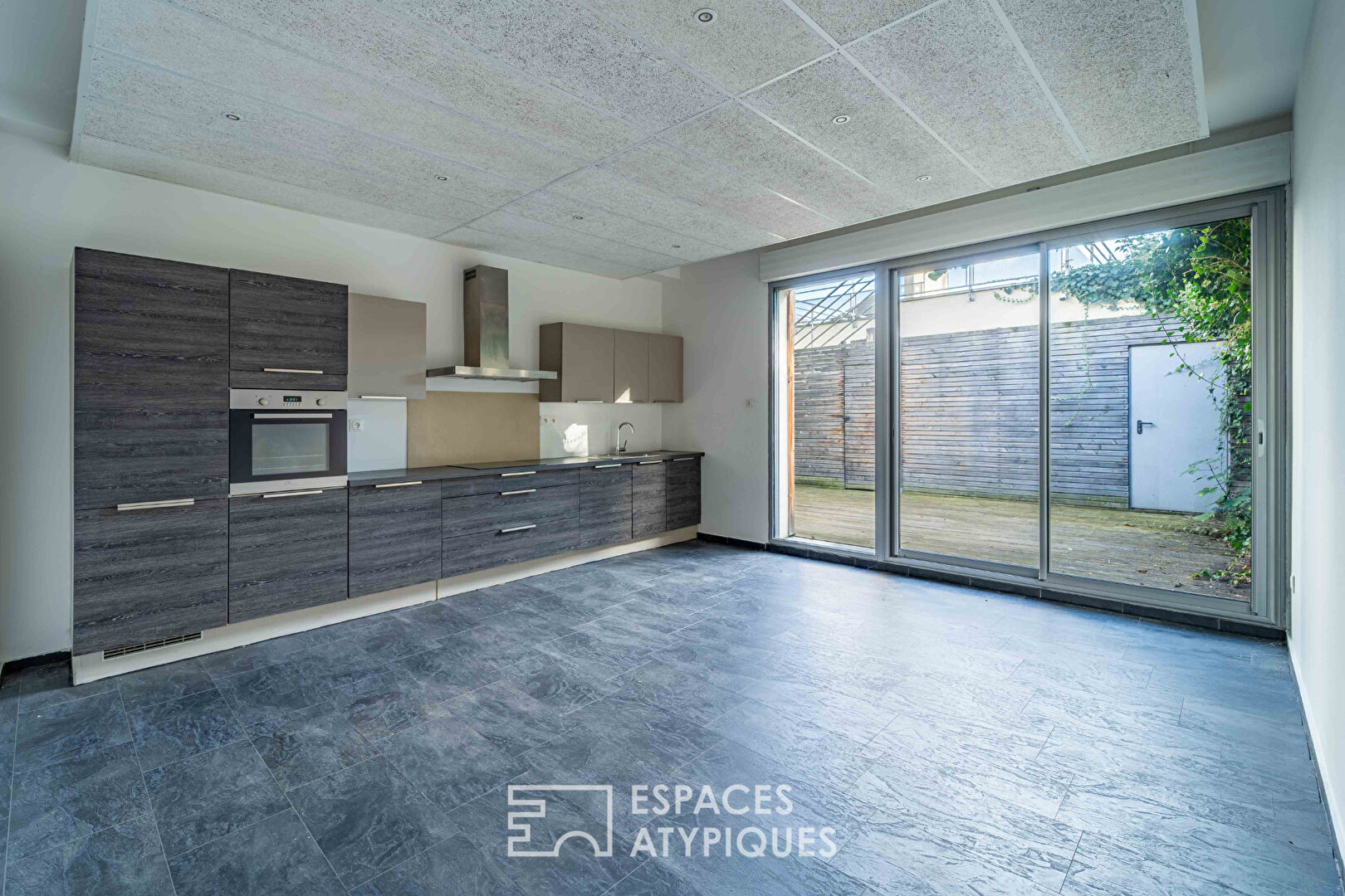 Loft et ses terrasses dans ancien supermarché