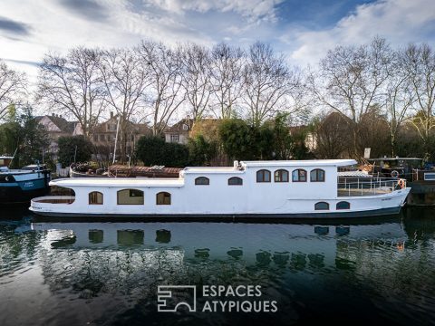 Renovated barge with two terraces on the water