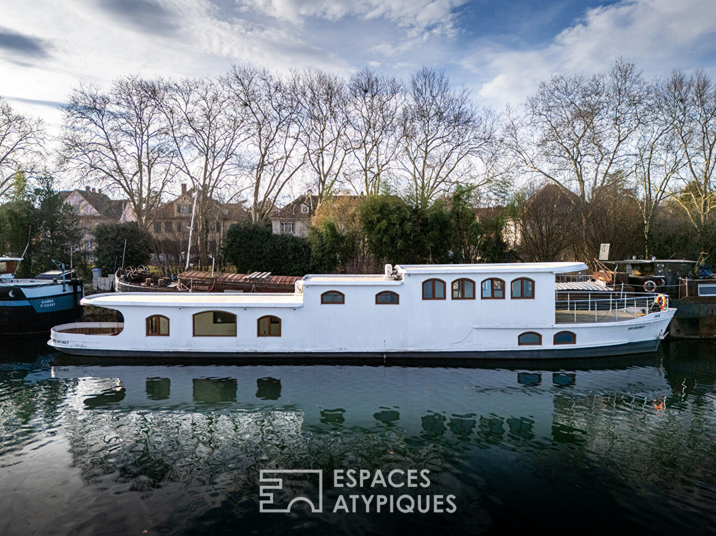 Renovated barge with two terraces on the water