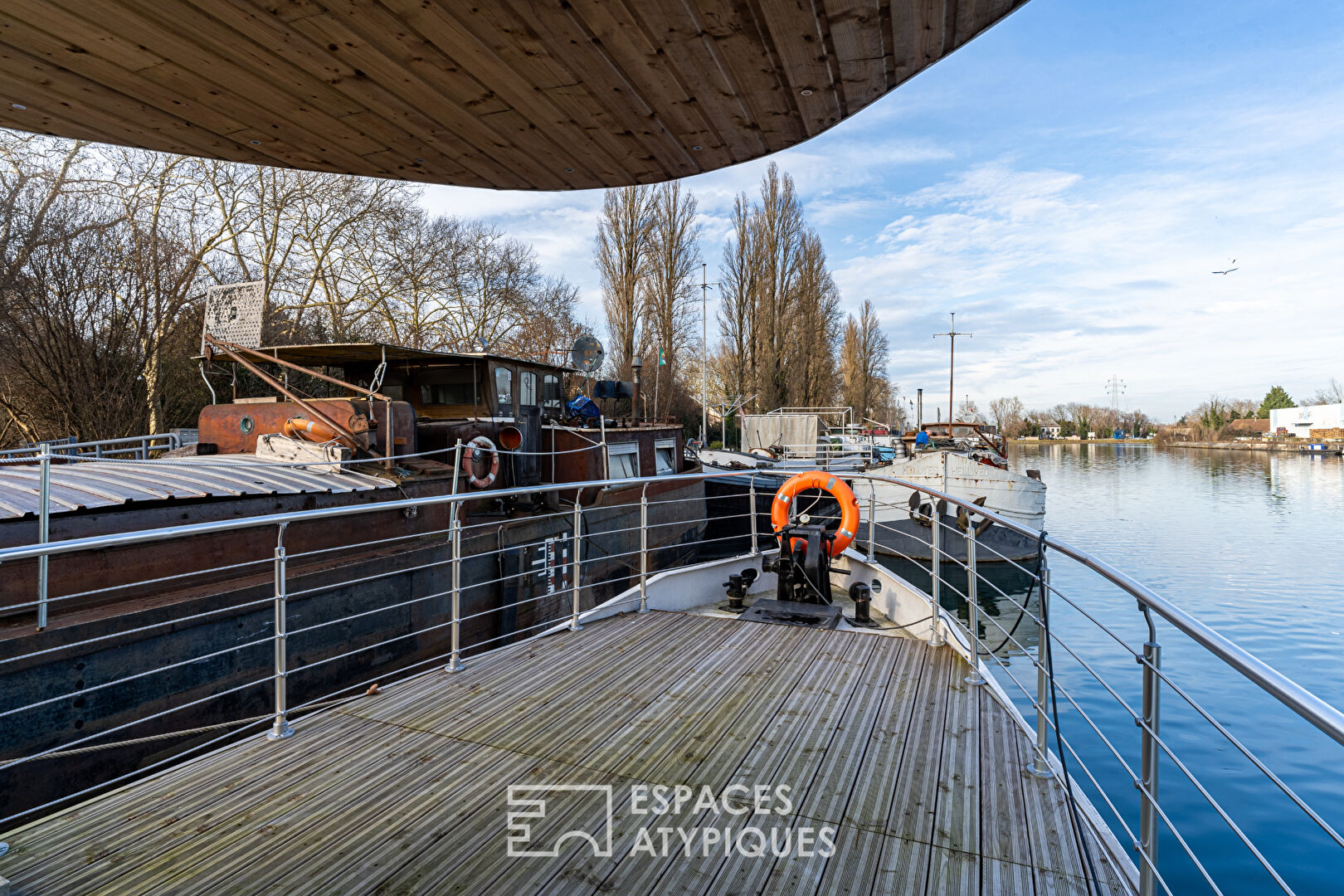 Renovated barge with two terraces on the water