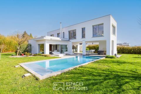 A contemporary home nestled in a secluded green setting