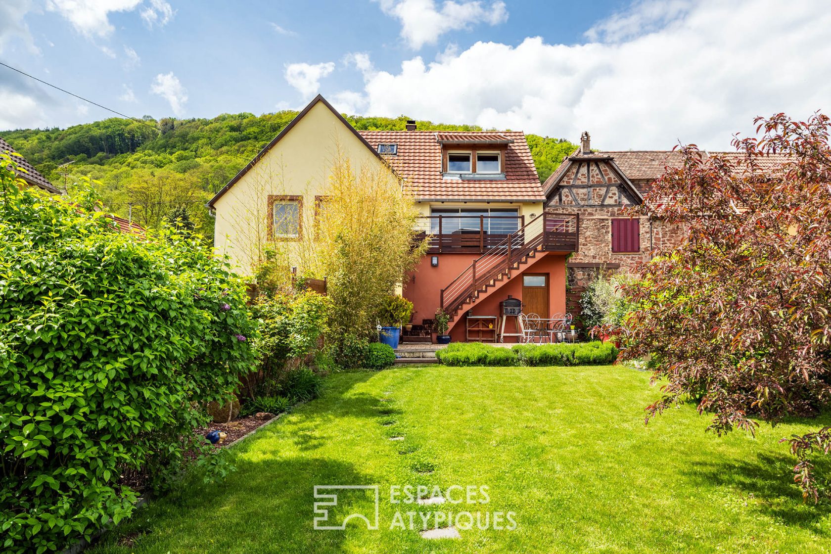 Contemporary farmhouse and its garden with trees
