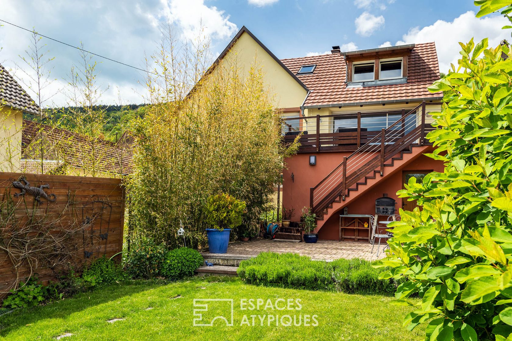 Contemporary farmhouse and its garden with trees