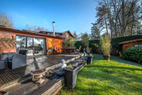 Wood frame house with stunning views of a lake