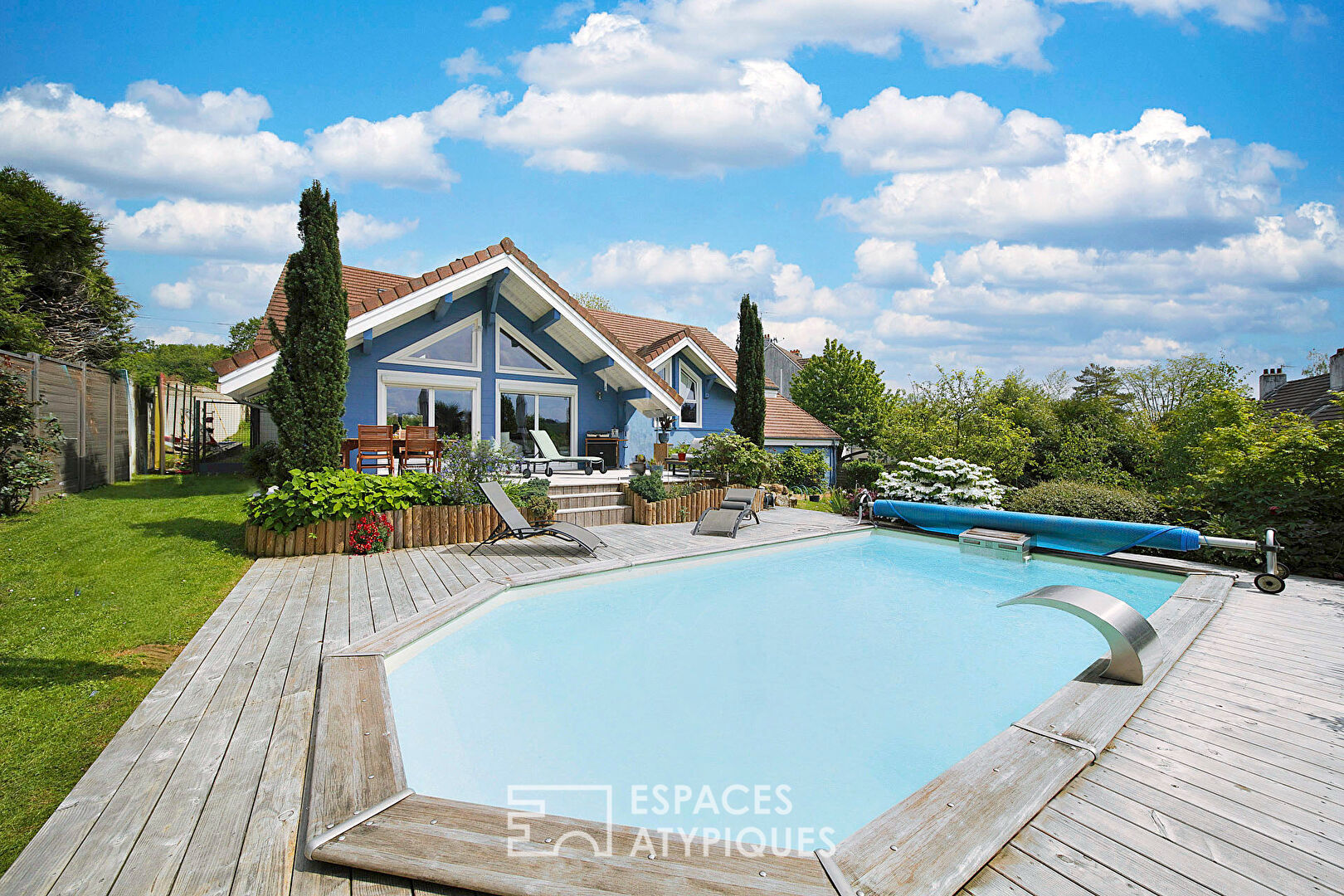 Wooden family house with swimming pool and garden