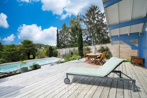 Wooden family house with swimming pool and garden