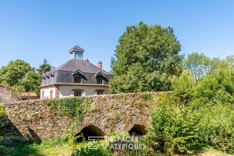 An old mill elegantly renovated between sky and river