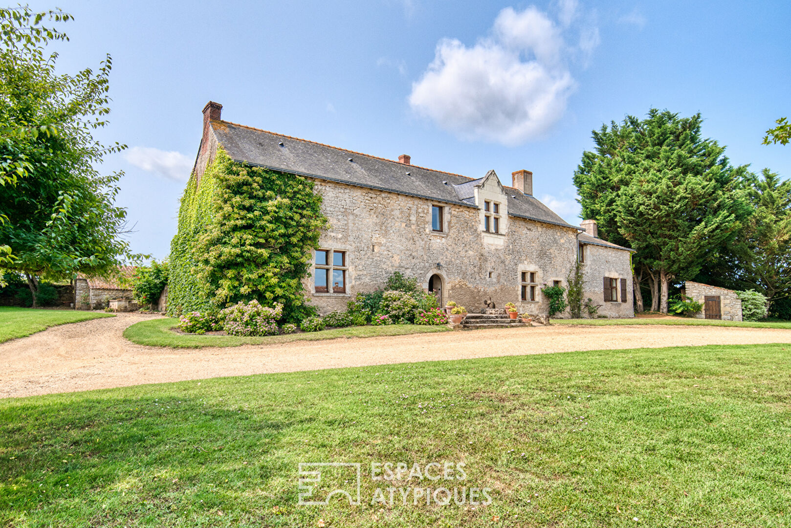 15th-century Seigneurie and its outbuildings in a verdant setting