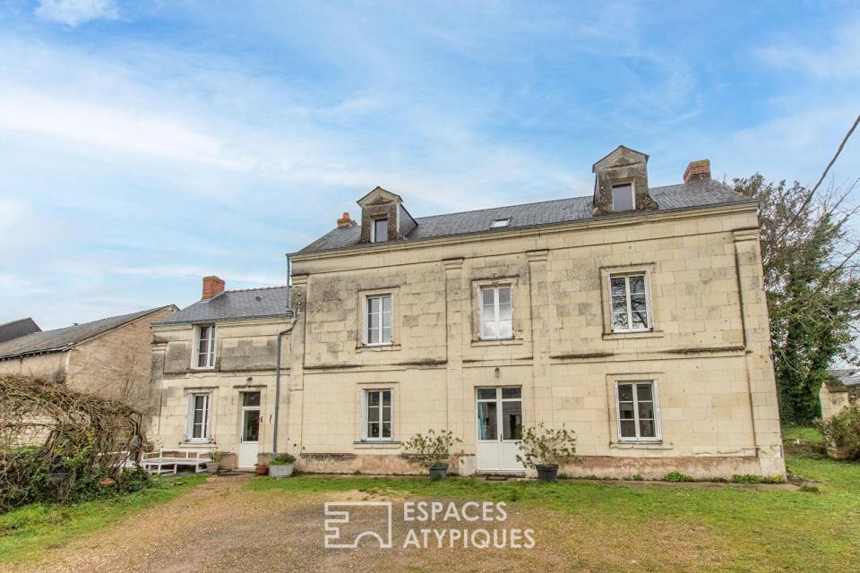 Maison de caractère avec grange et jardin arboré en coeur de village.