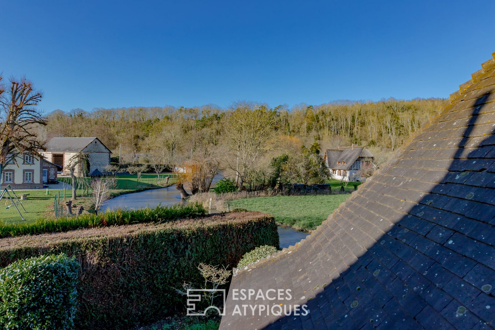 Anglo-Norman style house on the banks of the Iton and its outbuilding