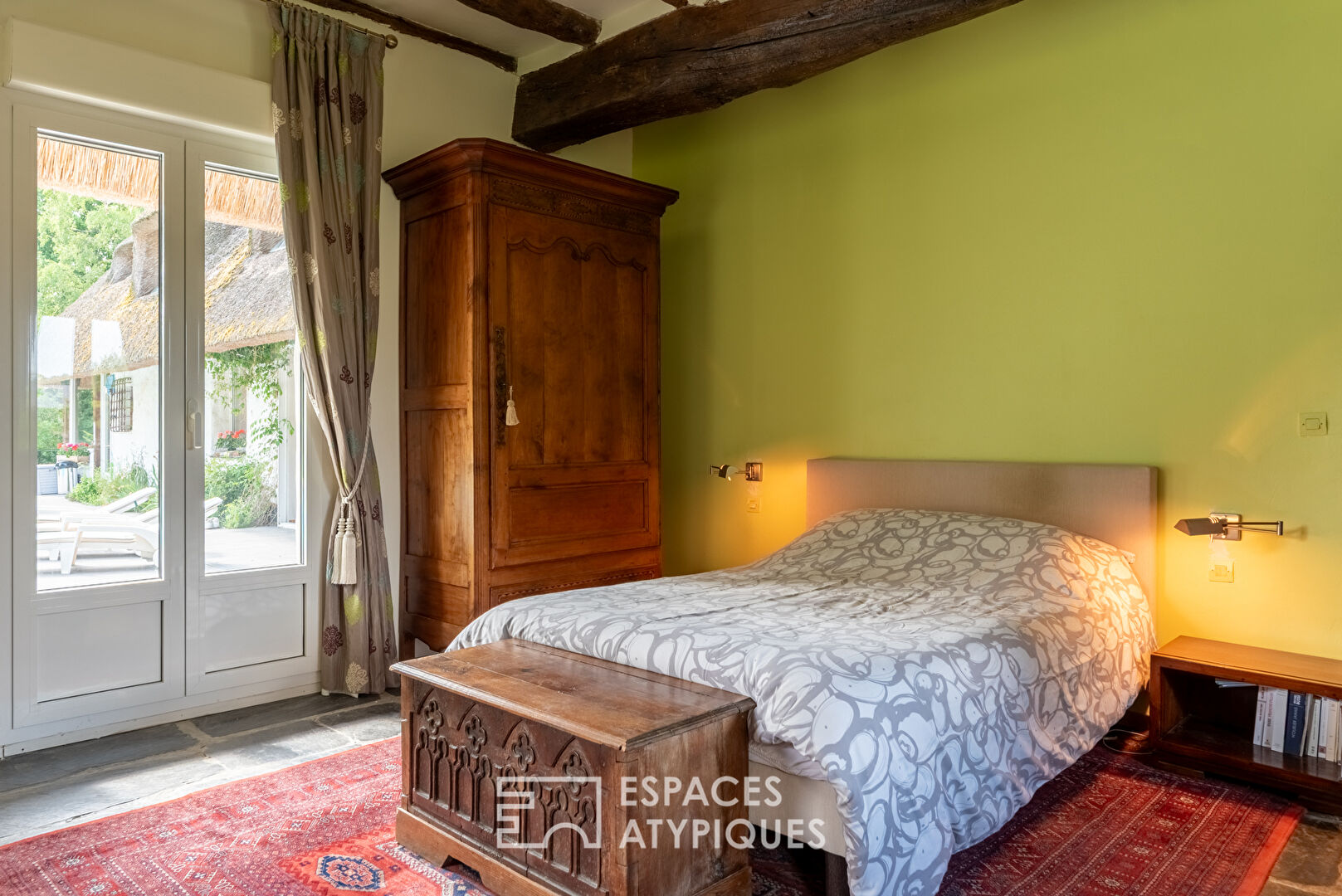 Thatched cottage with swimming pool in a green setting
