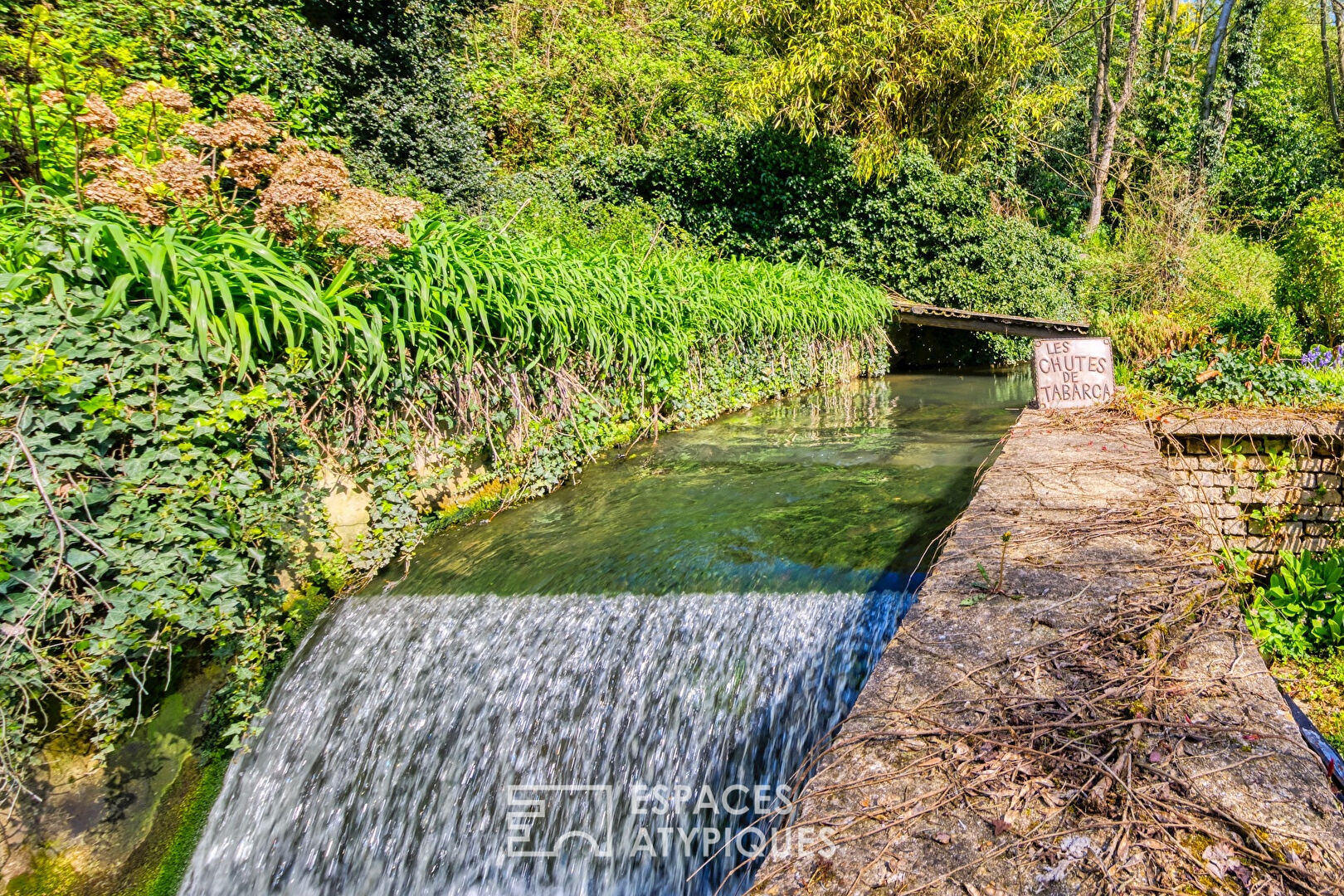 Sixties house on the site of an old watermill and its waterfalls