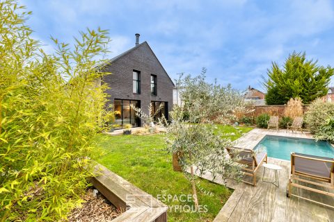 Black brick style house with swimming pool