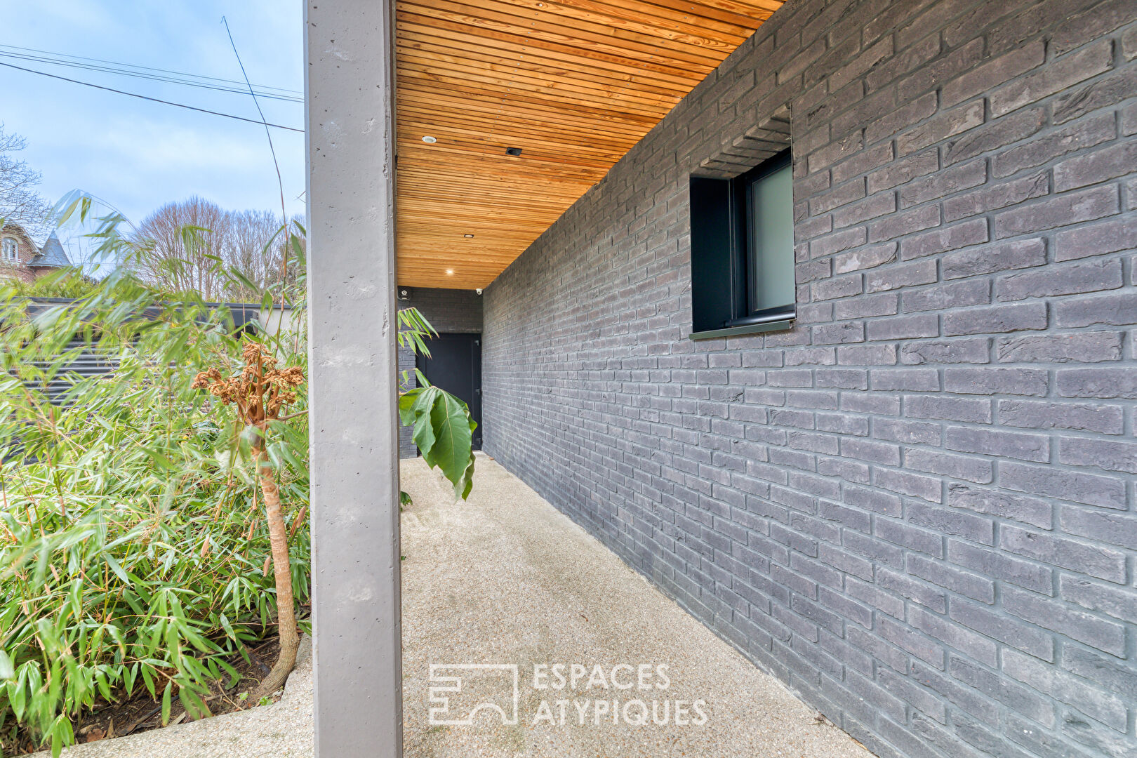 Black brick style house with swimming pool