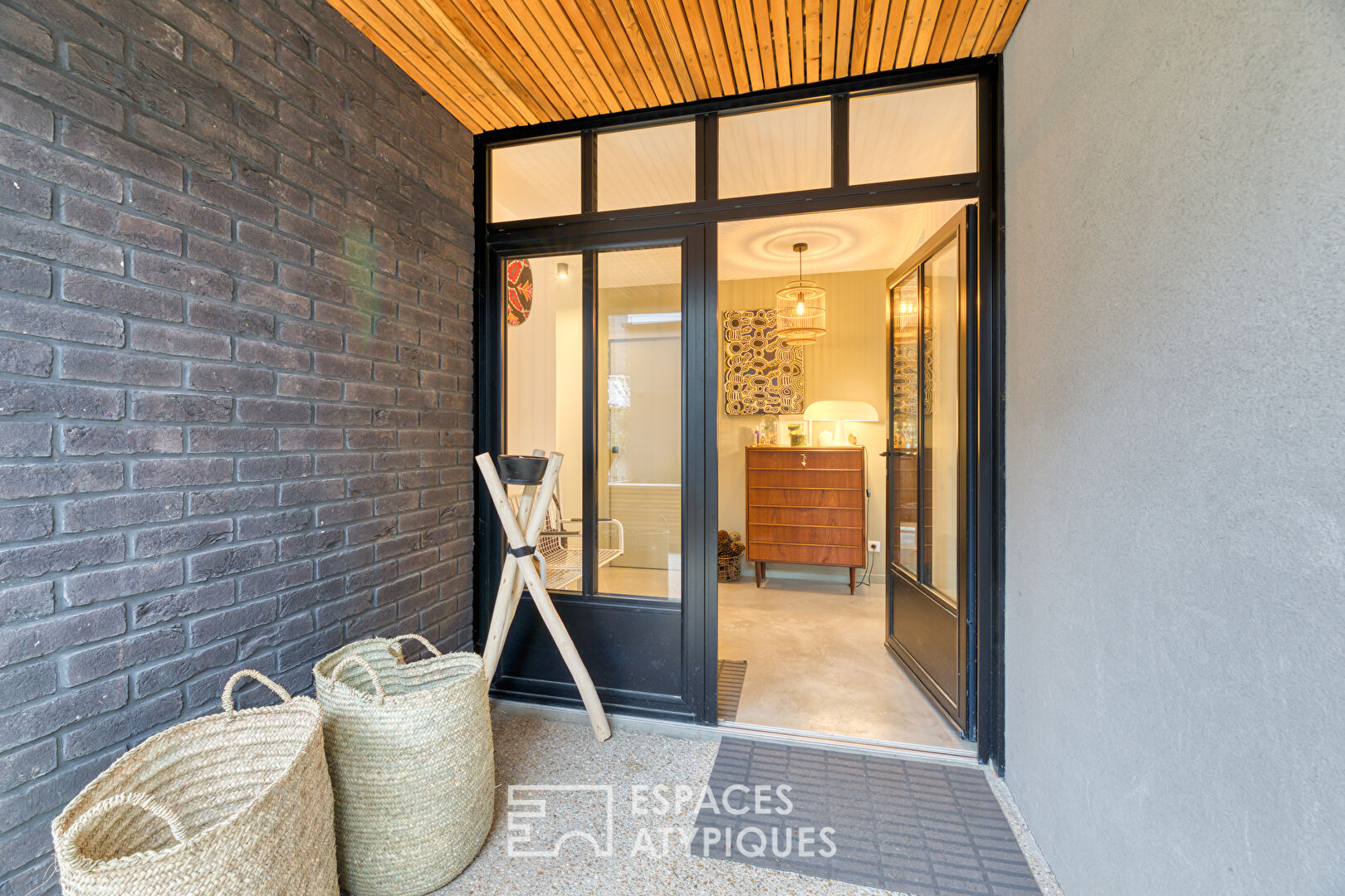 Black brick style house with swimming pool