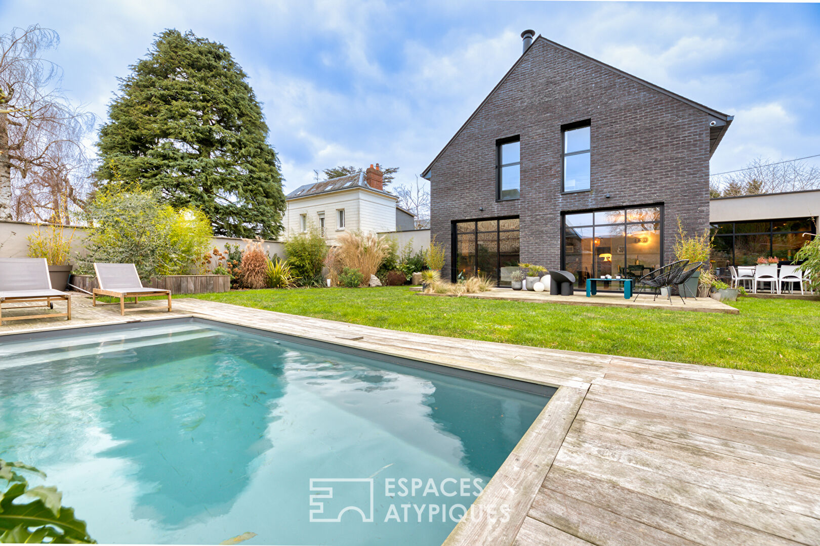 Black brick style house with swimming pool