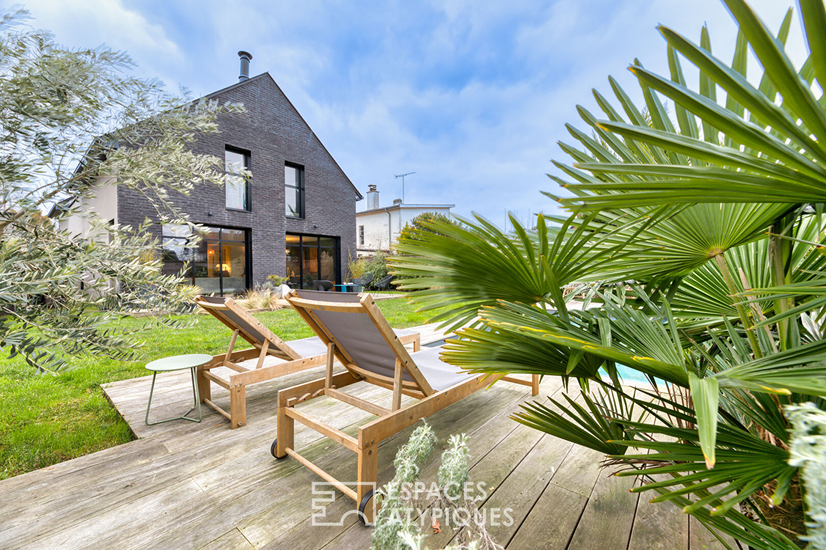 Black brick style house with swimming pool