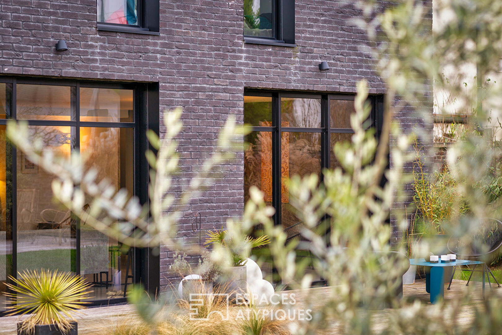 Black brick style house with swimming pool