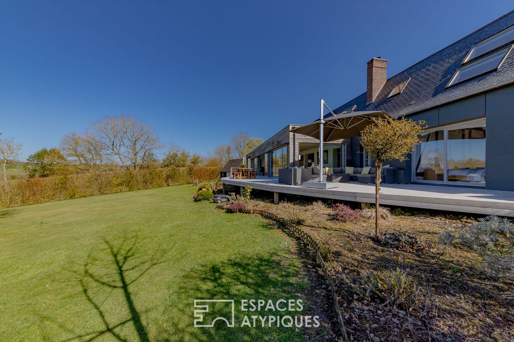 Revisited farmhouse with architect’s extension and view of the Normandy countryside